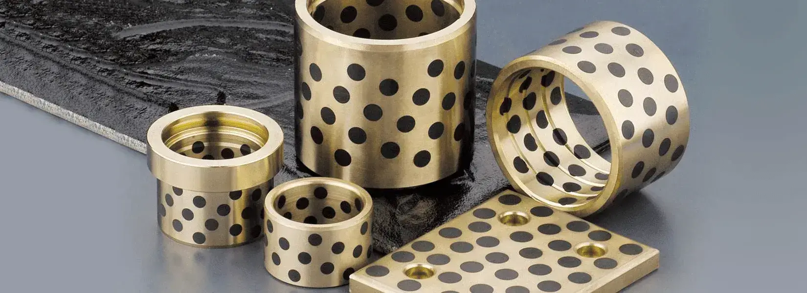 Graphite Plugged Bronze Bushings: Metallurgy, Solid-Lubricant Transfer, and Heavy-Duty Sliding Performance